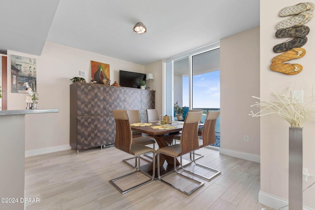 241 Riverside Dr Unit 1401-2, Holly Hill, FL 32117 - dining area with light wood-style flooring and baseboards