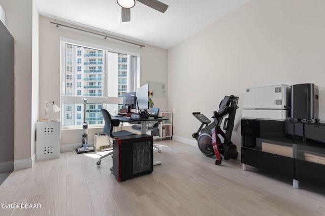 office area with plenty of natural light, light hardwood / wood-style floors, and ceiling fan