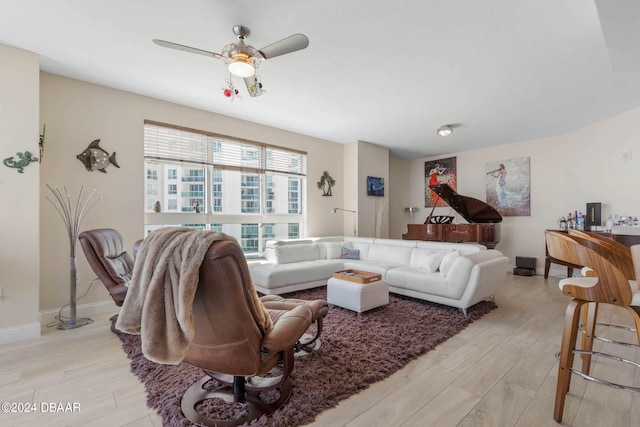 living room with light wood-type flooring and ceiling fan