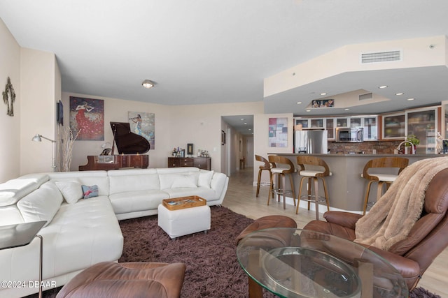 living room featuring light hardwood / wood-style floors and sink