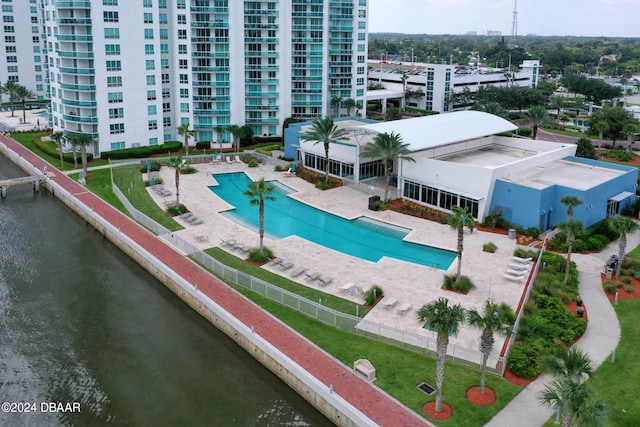 view of pool featuring a water view and a patio