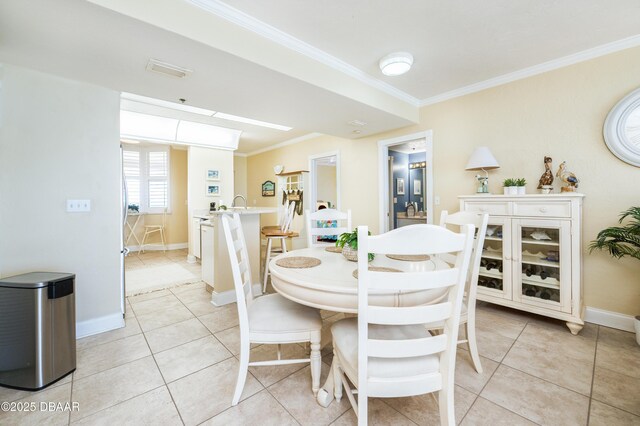 4545 S Atlantic Ave Unit 3704, Ponce Inlet, FL 32127 - dining area featuring crown molding, baseboards, and light tile patterned floors