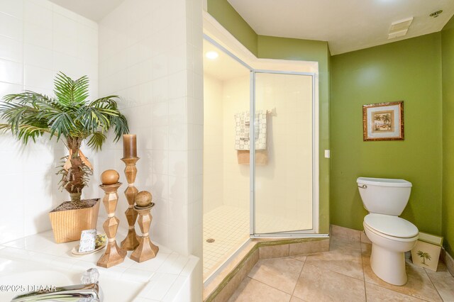 4545 S Atlantic Ave Unit 3704, Ponce Inlet, FL 32127 - bathroom featuring toilet, a shower stall, tile patterned floors, and a garden tub