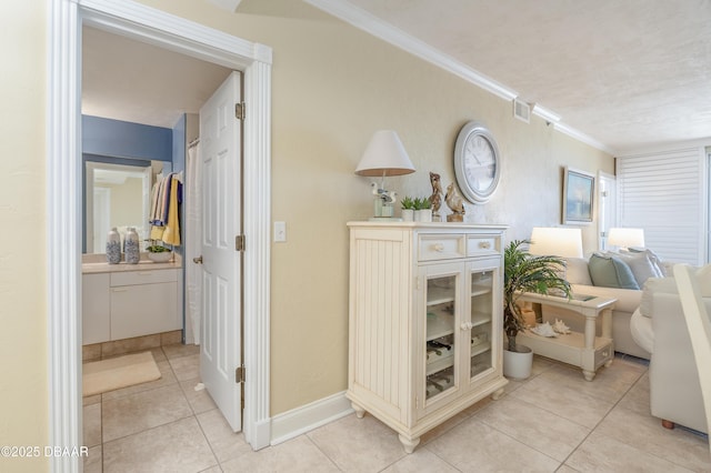 4545 S Atlantic Ave Unit 3704, Ponce Inlet, FL 32127 - hall with ornamental molding, light tile patterned flooring, baseboards, and visible vents