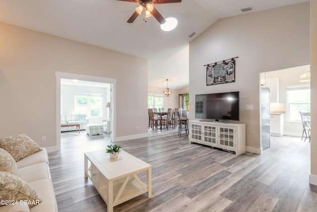 living room featuring high vaulted ceiling, hardwood / wood-style flooring, and ceiling fan