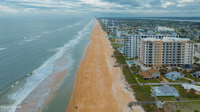 drone / aerial view featuring a view of the beach and a water view