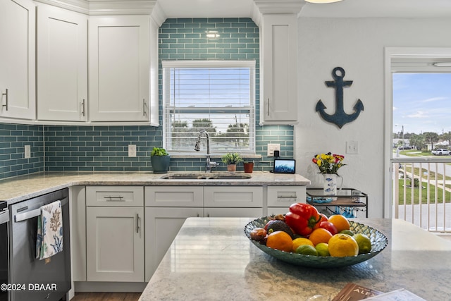 1510 Ocean Shore Blvd Unit 4120, Ormond Beach, FL 32176 - kitchen with a sink, stainless steel dishwasher, white cabinets, backsplash, and light stone countertops
