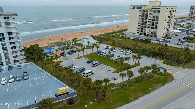 birds eye view of property featuring a beach view and a water view