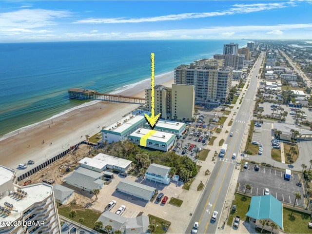 birds eye view of property with a view of the beach and a water view