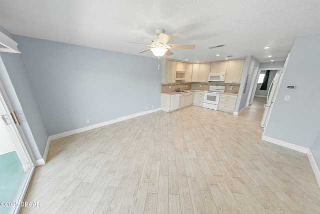 kitchen featuring sink, white appliances, ceiling fan, a textured ceiling, and light hardwood / wood-style flooring