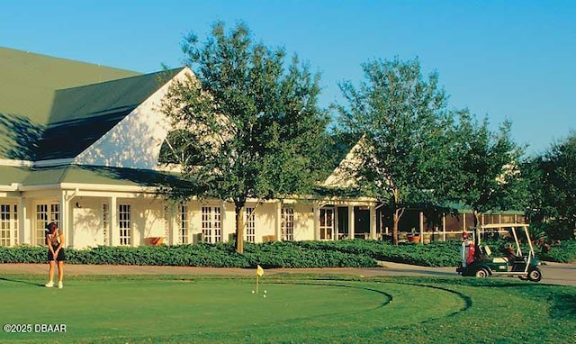 2798 Portadown St, Ormond Beach, FL 32174 - back of house featuring a putting green and stucco siding