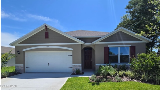 2798 Portadown St, Ormond Beach, FL 32174 - view of front of property with stone siding, driveway, a garage, and stucco siding
