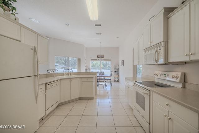 kitchen featuring decorative light fixtures, white cabinetry, sink, light tile patterned floors, and white appliances