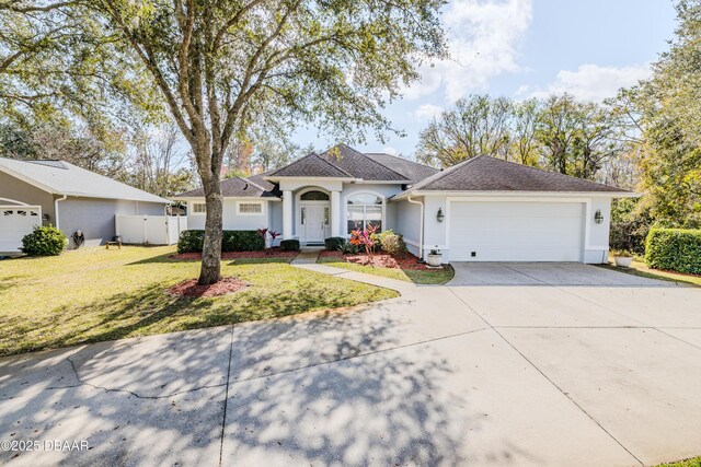 ranch-style house with a garage and a front lawn