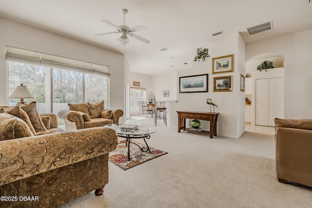 carpeted living room with ceiling fan