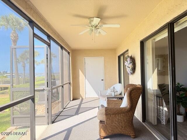 460 Bouchelle Dr Unit 104, New Smyrna Beach, FL 32169 - sunroom with a ceiling fan and carpet