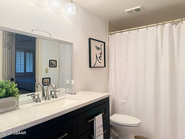 460 Bouchelle Dr Unit 104, New Smyrna Beach, FL 32169 - bathroom with visible vents, toilet, and vanity