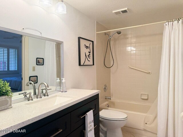 460 Bouchelle Dr Unit 104, New Smyrna Beach, FL 32169 - bathroom with a textured ceiling, visible vents, shower / tub combo, vanity, and toilet