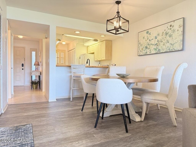 460 Bouchelle Dr Unit 104, New Smyrna Beach, FL 32169 - dining area featuring baseboards, recessed lighting, wood finished floors, and a notable chandelier