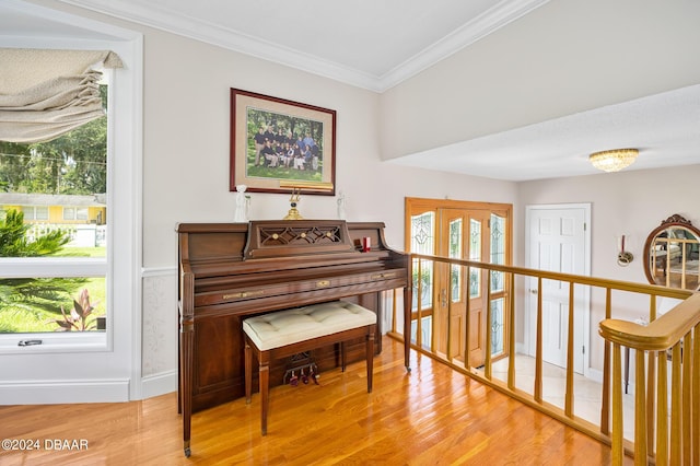 miscellaneous room with wood-type flooring and crown molding