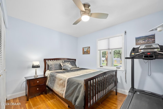 bedroom with light hardwood / wood-style flooring and ceiling fan