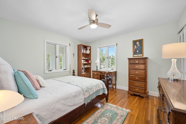 bedroom with a closet, ceiling fan, and light hardwood / wood-style flooring