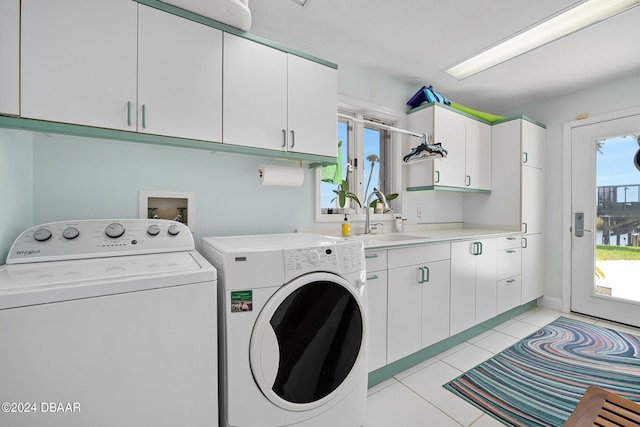 laundry room with separate washer and dryer, sink, light tile patterned flooring, and cabinets