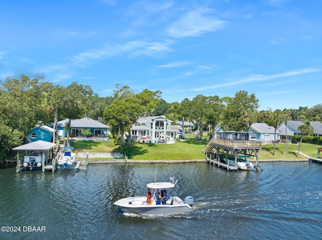 dock area with a lawn and a water view