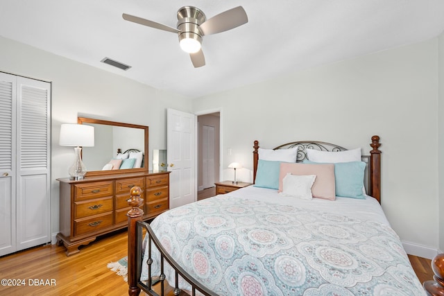 bedroom featuring ceiling fan, light hardwood / wood-style flooring, and a closet