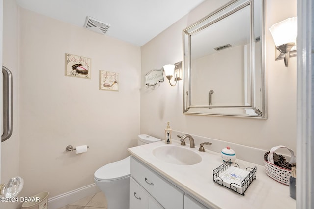 bathroom featuring toilet, vanity, and tile patterned floors