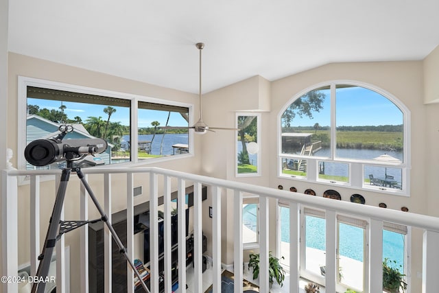 room details featuring ceiling fan and a water view