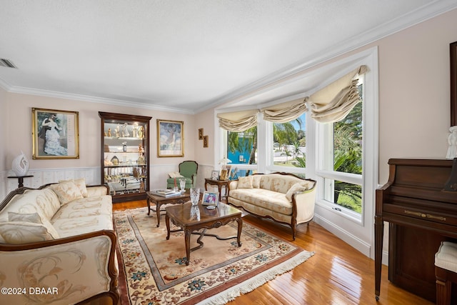 living room featuring light hardwood / wood-style floors and crown molding