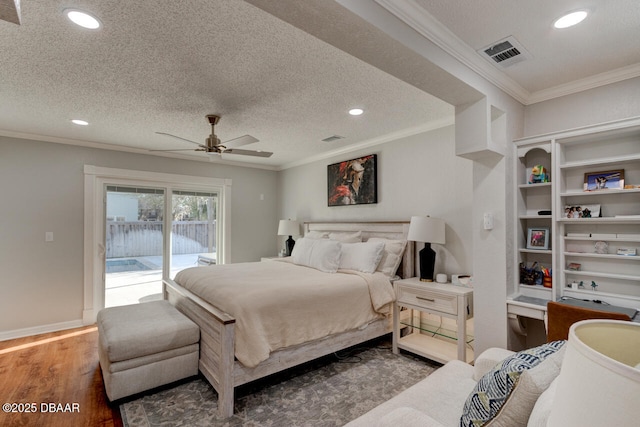 bedroom with access to outside, crown molding, a textured ceiling, and wood finished floors