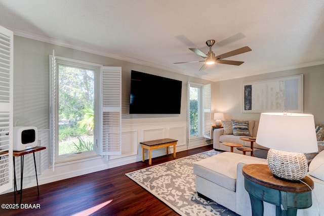 living area featuring dark wood-style floors, plenty of natural light, and crown molding