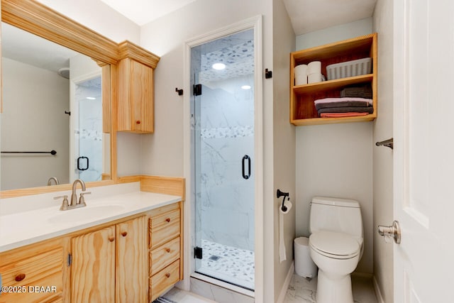 bathroom featuring toilet, marble finish floor, a marble finish shower, and vanity