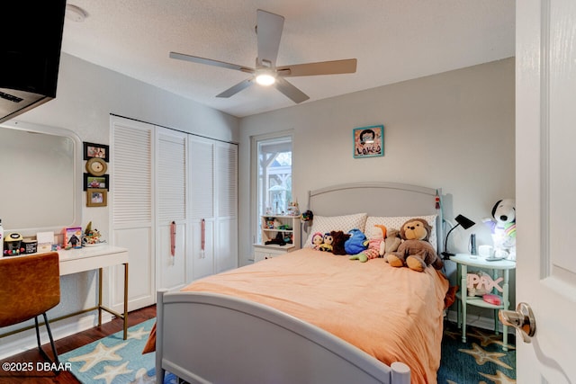 bedroom with a closet, ceiling fan, a textured ceiling, and wood finished floors