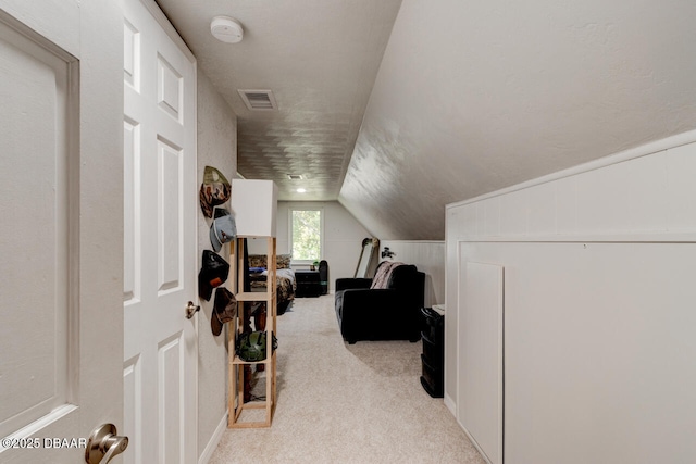 additional living space with carpet, visible vents, and lofted ceiling