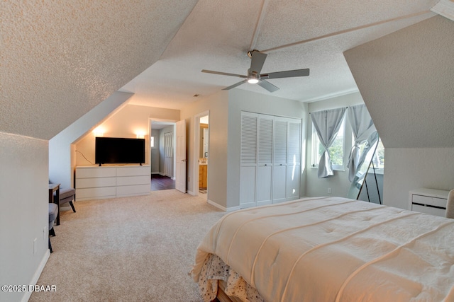 bedroom featuring ceiling fan, a textured ceiling, baseboards, a closet, and carpet