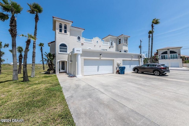 view of front of home featuring a front yard and a garage