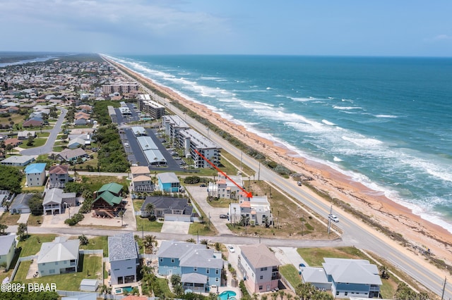 drone / aerial view with a water view and a view of the beach