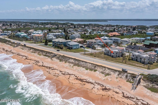 aerial view with a water view and a beach view