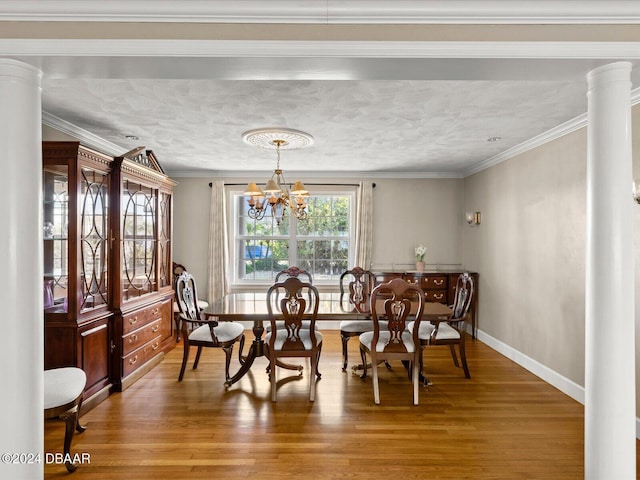 dining room with hardwood / wood-style flooring, an inviting chandelier, and ornamental molding