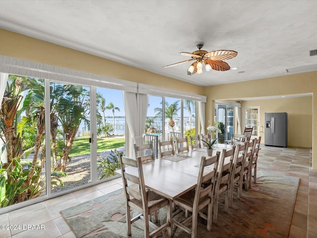 dining area featuring ceiling fan and light tile patterned floors