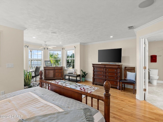 bedroom featuring ensuite bathroom, light hardwood / wood-style floors, ornamental molding, and ceiling fan