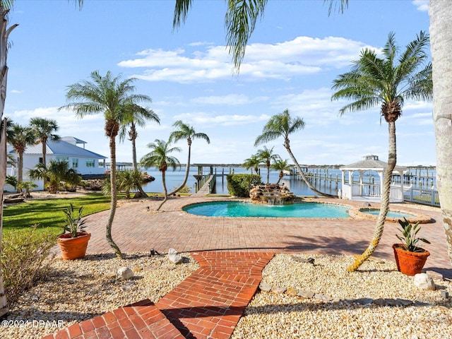 view of pool with a patio area and a water view