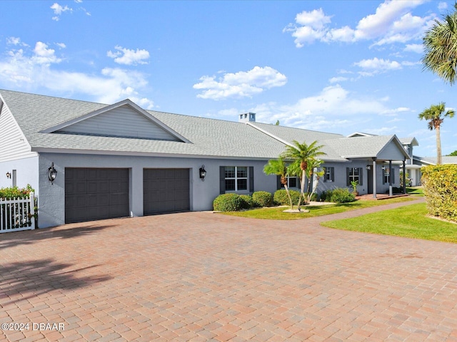 ranch-style home featuring a garage