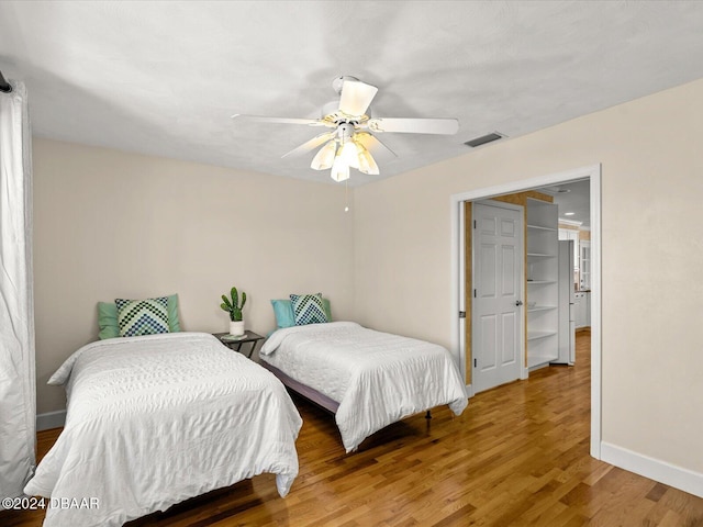 bedroom with ceiling fan and hardwood / wood-style floors