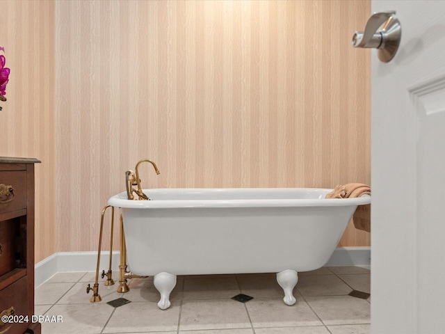 bathroom with tile patterned flooring and a bath