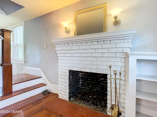 room details with wood-type flooring and a fireplace