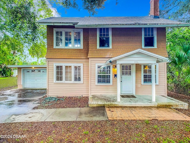 view of front of home with a garage and a porch